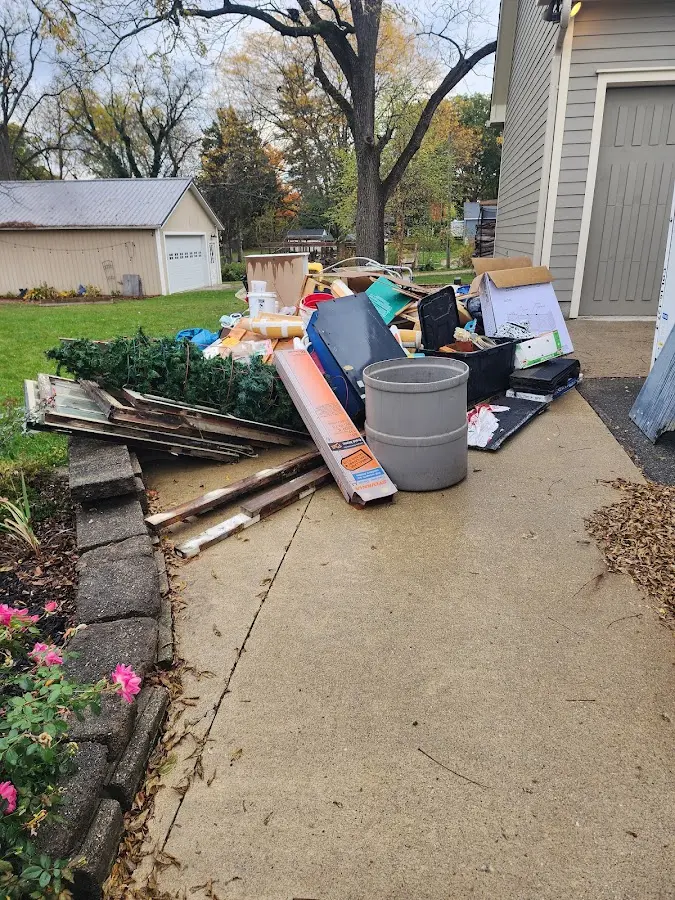 Dumpster being loaded with debris for 12 Yard Dumpster Rental in Union City